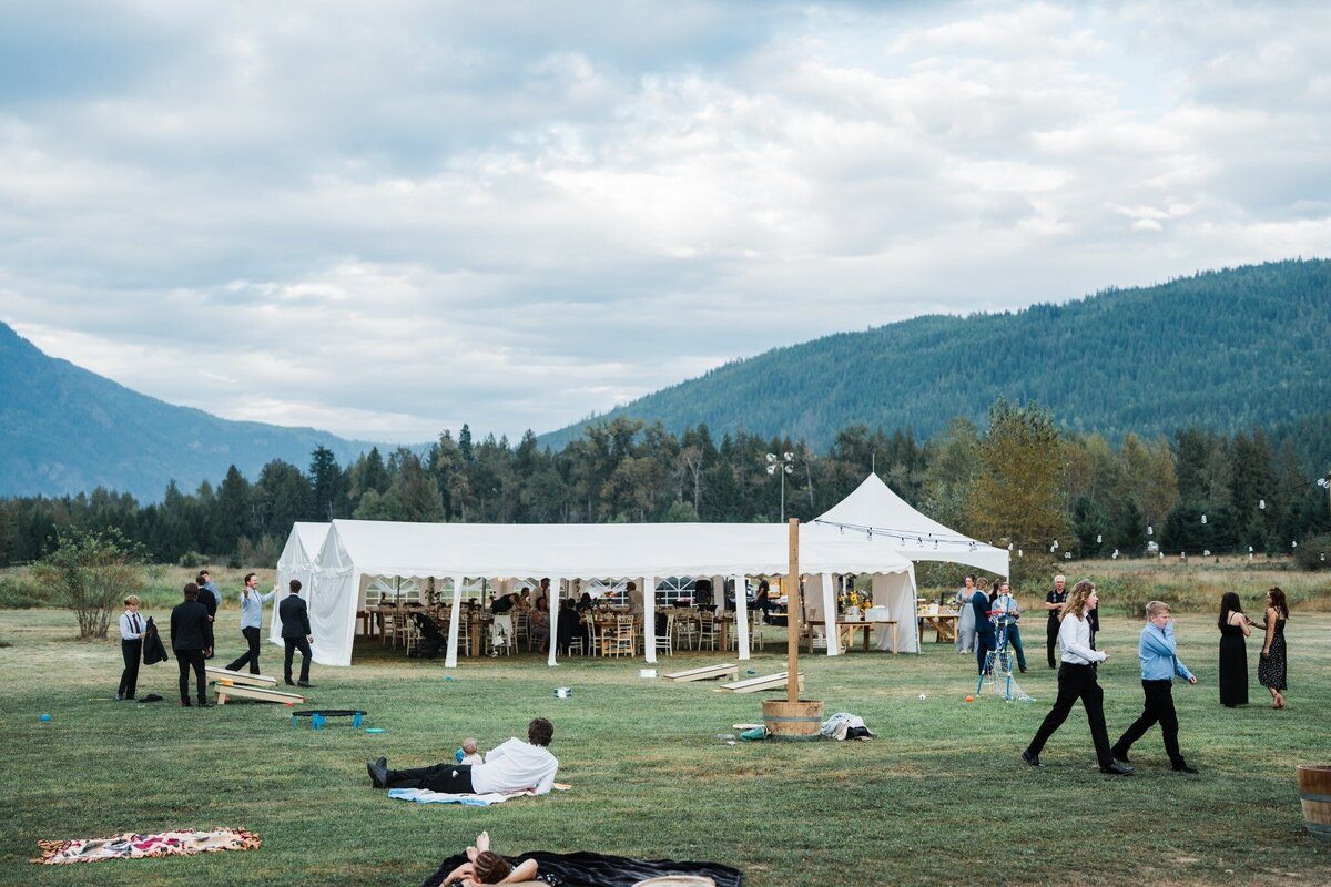 The open meadow with reception tent and mountain views